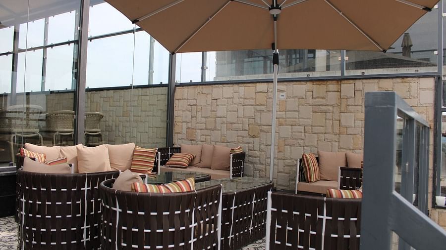 Back view of a rooftop lounge featuring stylish seating arrangements and a spacious patio area at BluSalzz Residence, Amritsar 